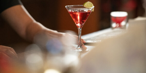 A cranberry martini with a juicy slice of lime sits atop the Paradise Valley Estates' bar top.