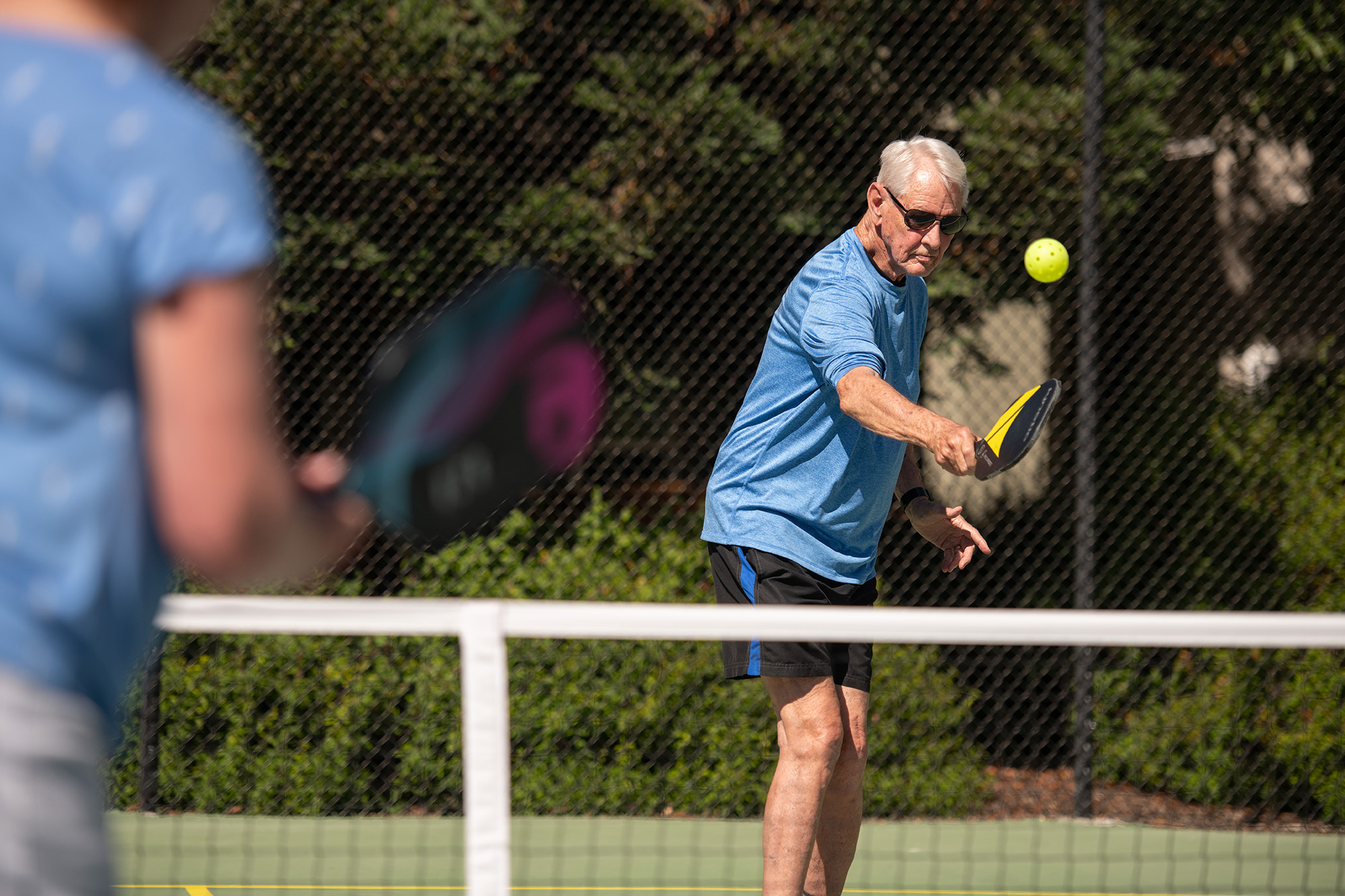 Playing tennis on outdoor court